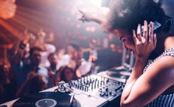 Young woman playing music at the club